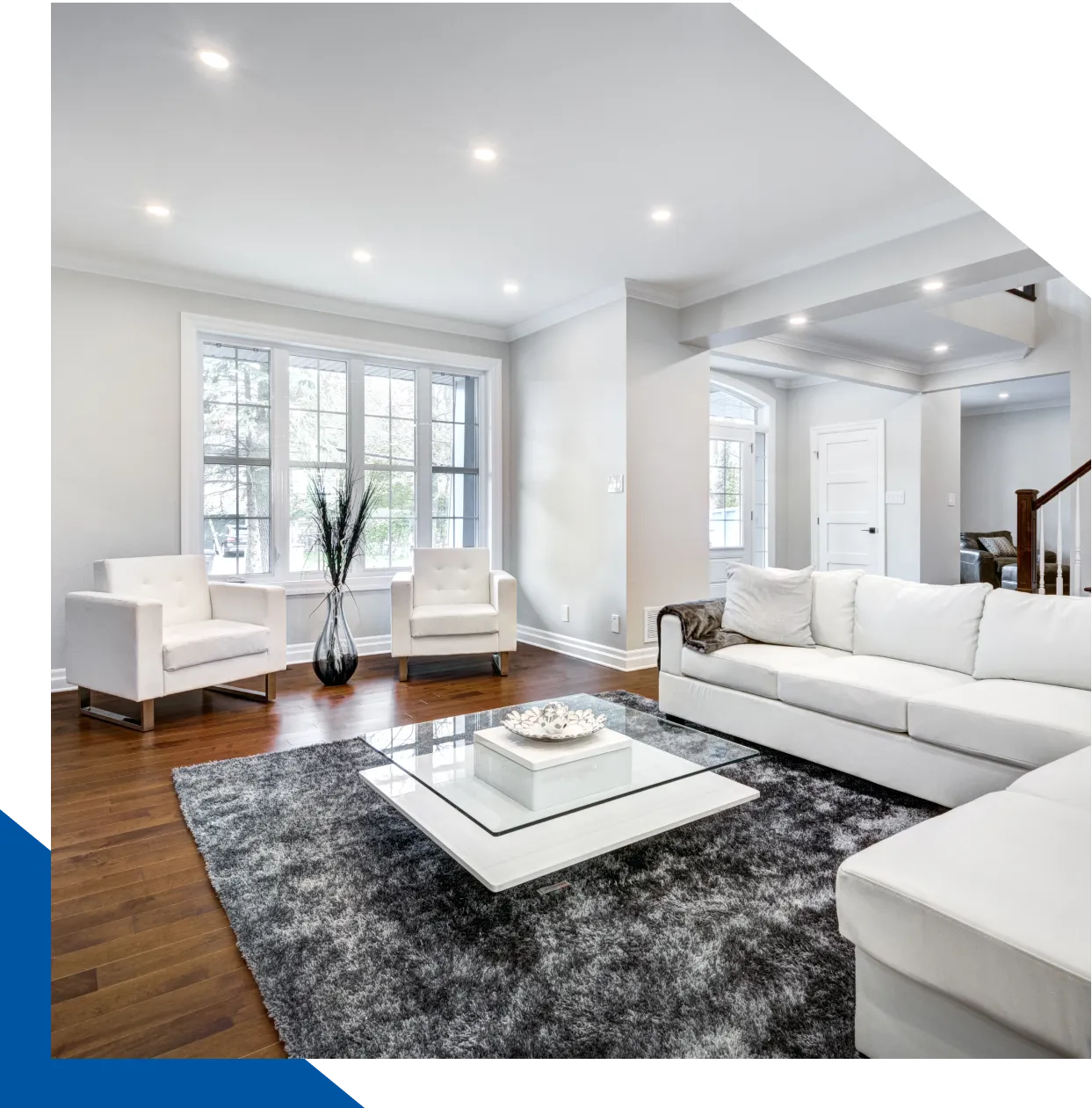 Modern living room with white furniture.