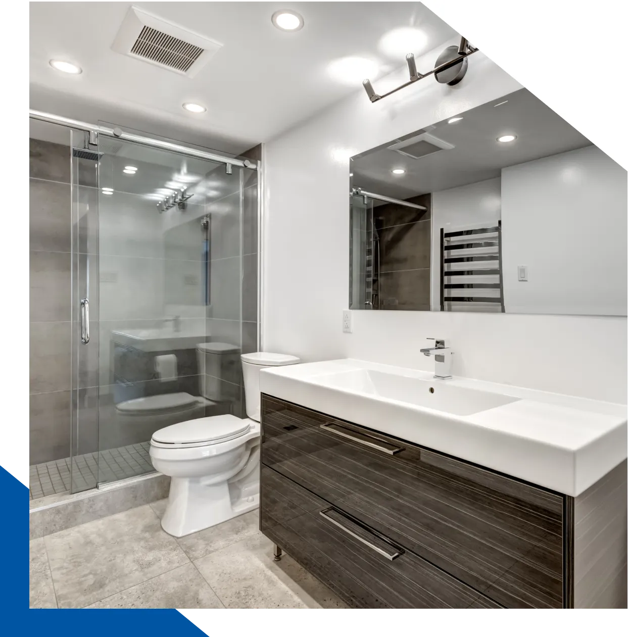 Modern bathroom with glass shower and vanity.