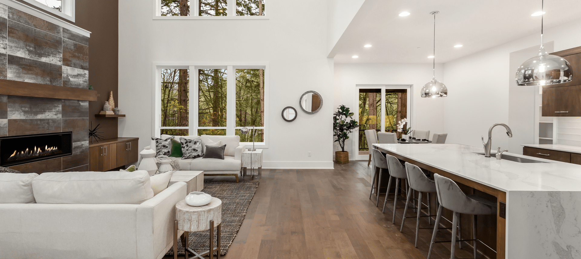 Modern living room with fireplace and kitchen island.